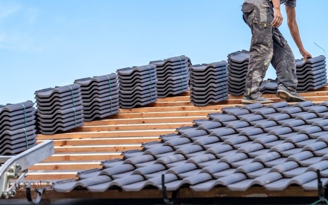 image of man placing roof tiles